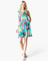 Beach Rose Co. sleeveless green swing dress with a vibrant tropical floral print, notched V-neck, and side pockets.