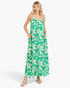 Beach Rose Co. green maxi dress with ivory tropical leaf print, V-neckline, and side pockets on a blonde model.