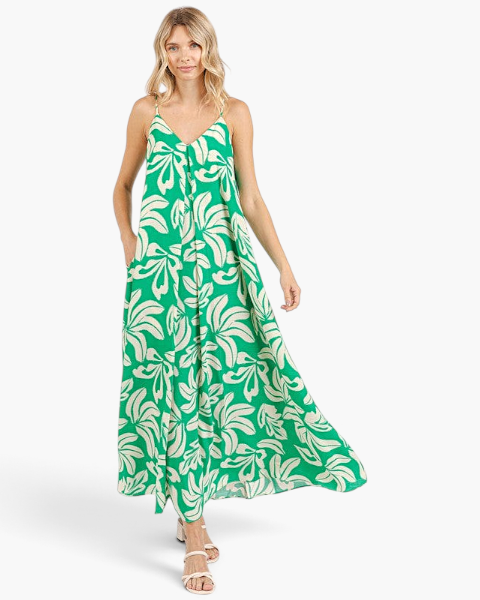 Beach Rose Co. green and ivory tropical print maxi dress with V-neck, adjustable straps, and side pockets on a model.