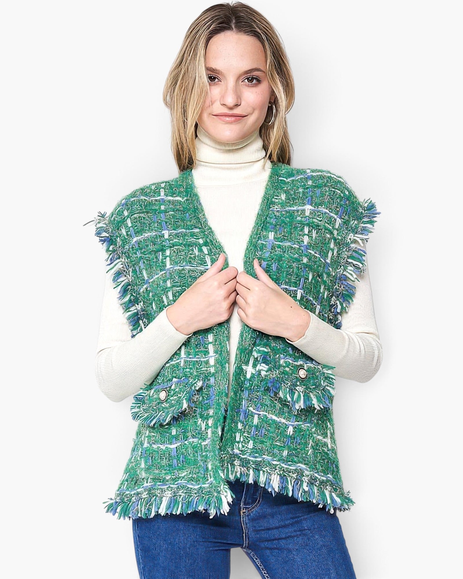 Beach Rose Co. green plaid tweed vest with frayed edges and buttoned flap pockets worn over a cream turtleneck.