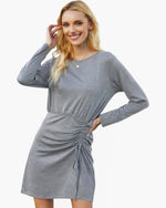 Beach Rose Co. grey long-sleeve crew neck dress with a high-waisted drawstring detail worn by a smiling blonde model.