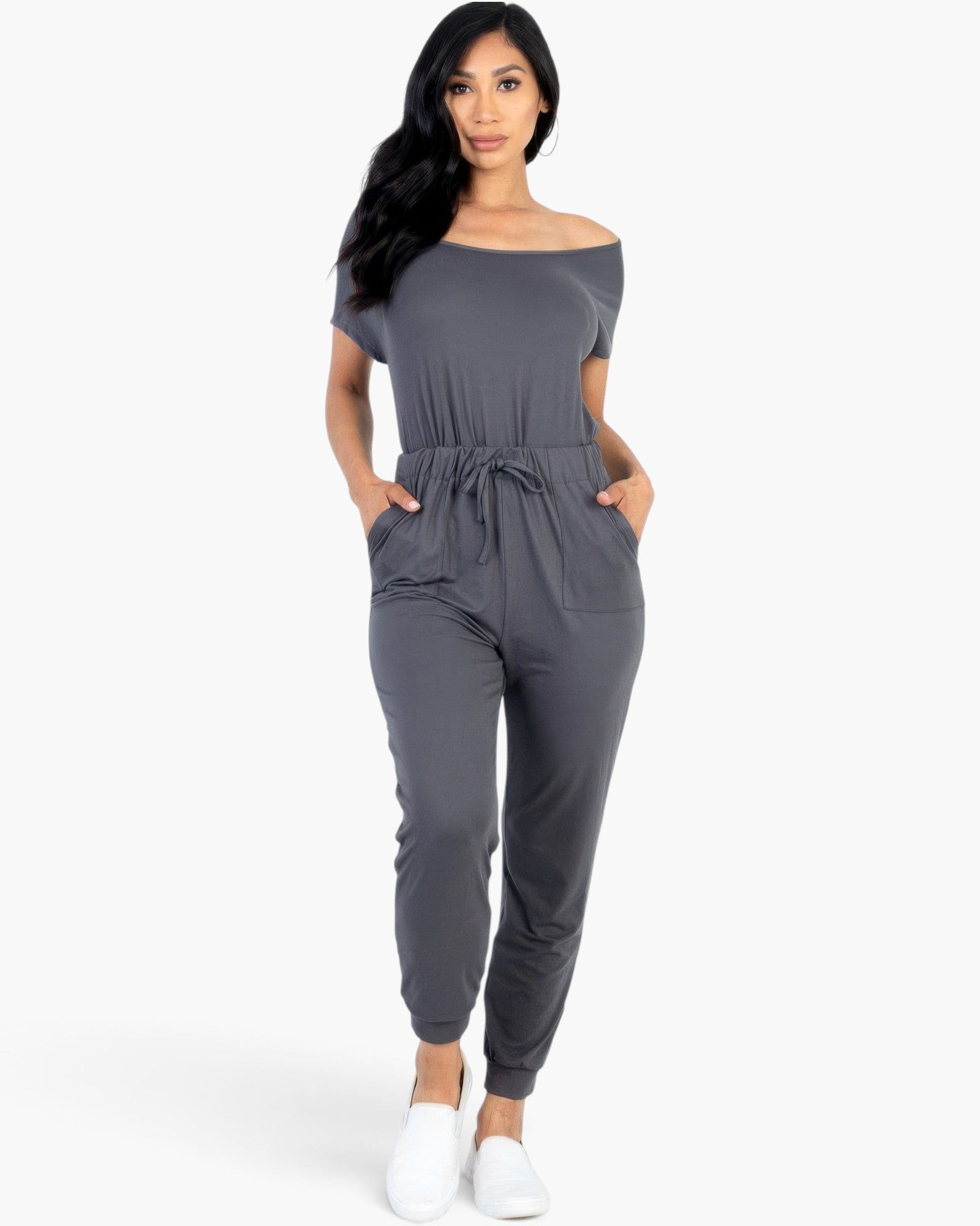 Beach Rose Co. grey off-the-shoulder drawstring jumpsuit with tapered legs and pockets worn by a model