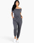 Beach Rose Co. grey off-the-shoulder drawstring jumpsuit with tapered legs and pockets worn by a model