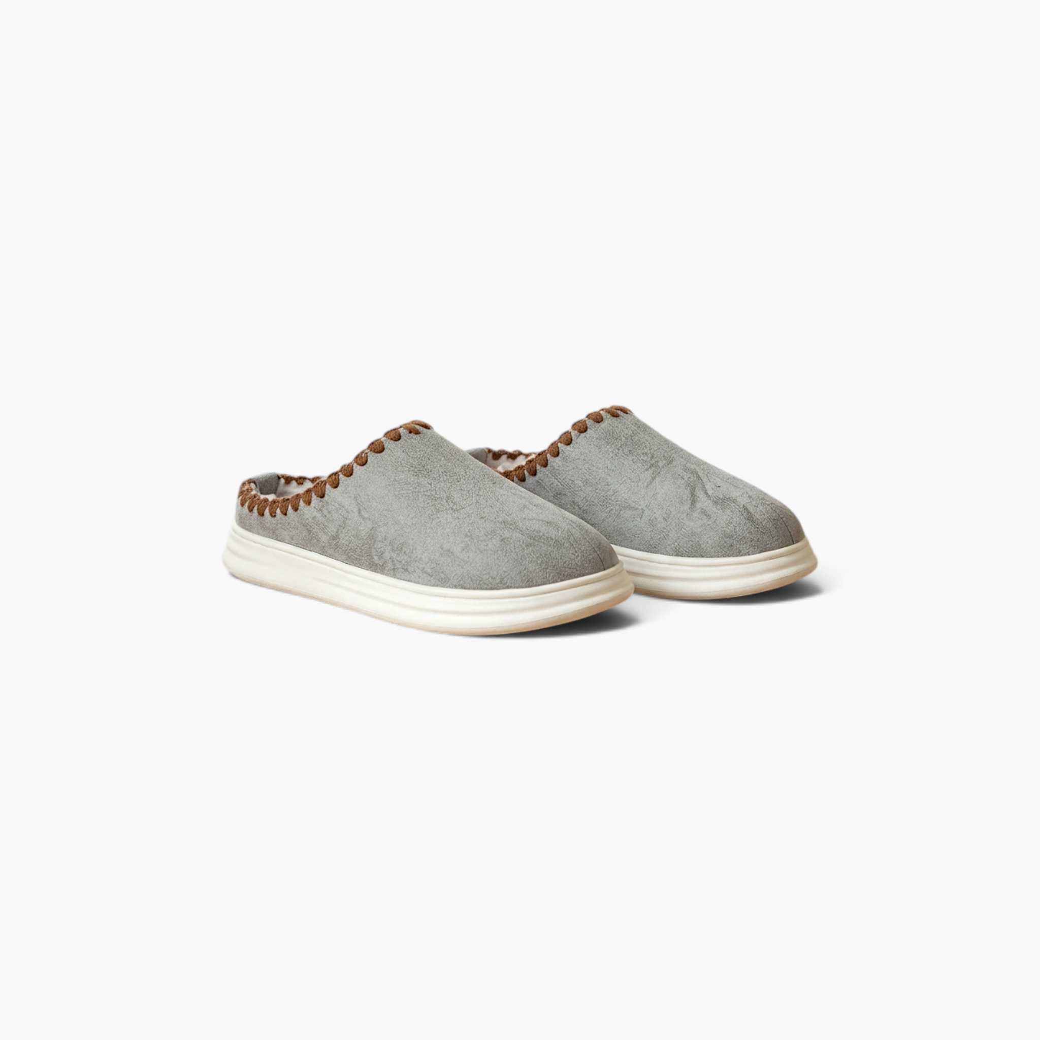 Beach Rose Co. Paula plush lined grey home slippers with thick white soles and decorative brown stitched trim.