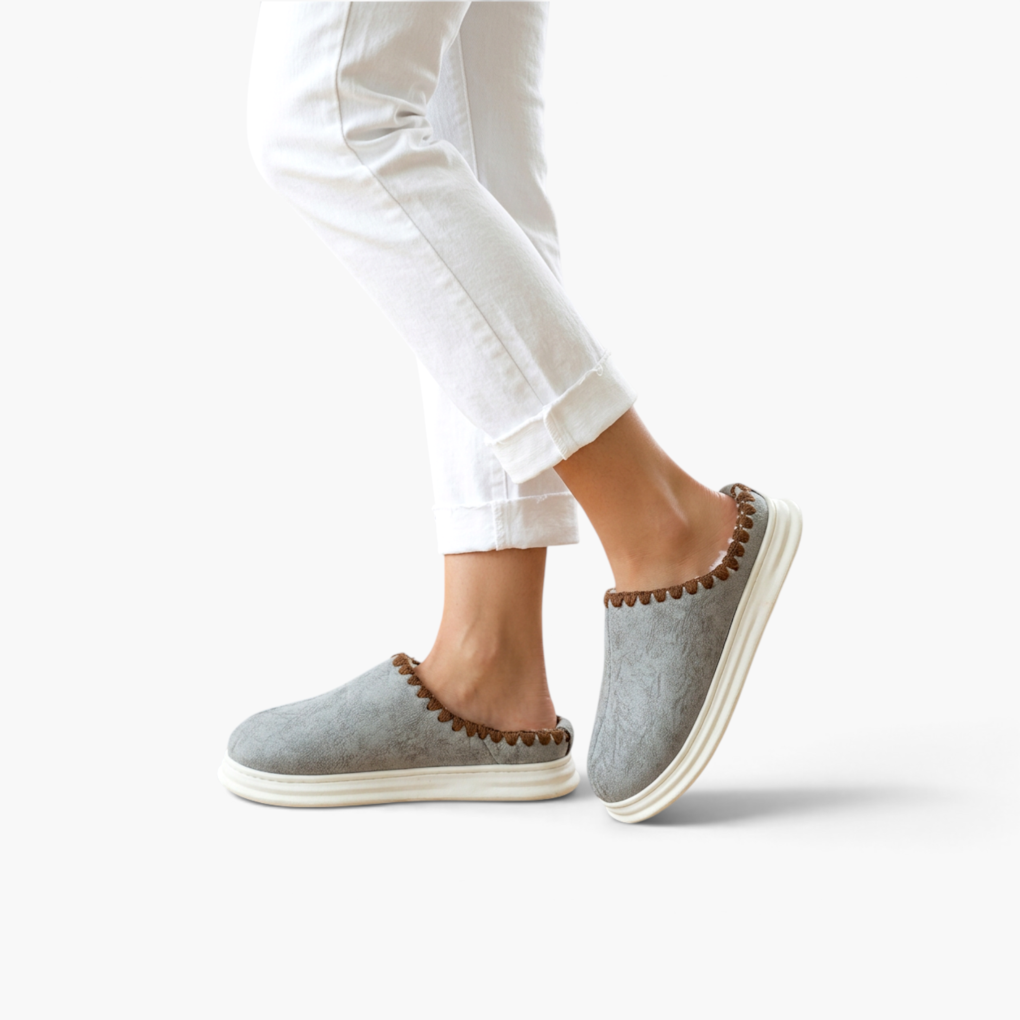 Beach Rose Co. Paula plush-lined grey slippers with thick white soles and brown stitched trim on a model