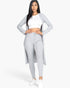 Beach Rose Co. grey ribbed long cardigan and leggings set worn by a model with a white crop top and sneakers