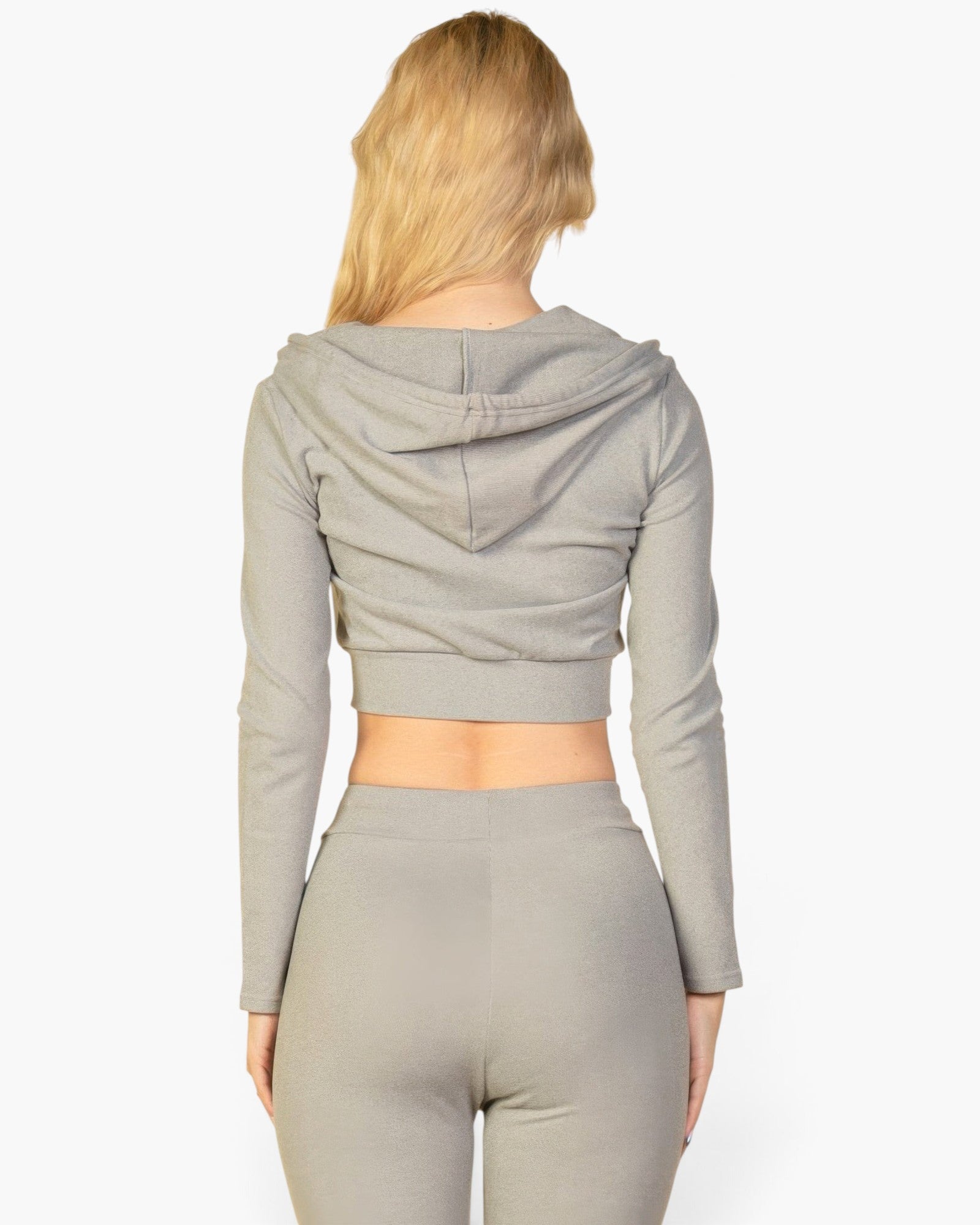 Back view of a woman wearing a Beach Rose Co. grey ribbed crop zip hoodie with long sleeves and a hood.