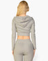 Back view of a woman wearing a Beach Rose Co. grey ribbed crop zip hoodie with long sleeves and a hood.