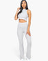 Beach Rose Co. grey ribbed mock neck crop tank top and matching bootcut pants worn by a woman on a white background.