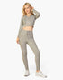 Beach Rose Co. model wearing grey ribbed tie-front lounge leggings and a matching cropped zip-up hoodie