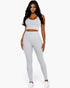 Beach Rose Co. model wearing a light grey ribbed crop top and high-waisted leggings set for a sleek activewear look.