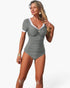 Beach Rose Co. grey short-sleeve one-piece swimsuit with white contrast trim, ruched front, and decorative center detail
