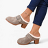 Beach Rose Co. grey suede clogs with fluffy trim, oversized buckle, and chunky block heel worn with blue jeans.
