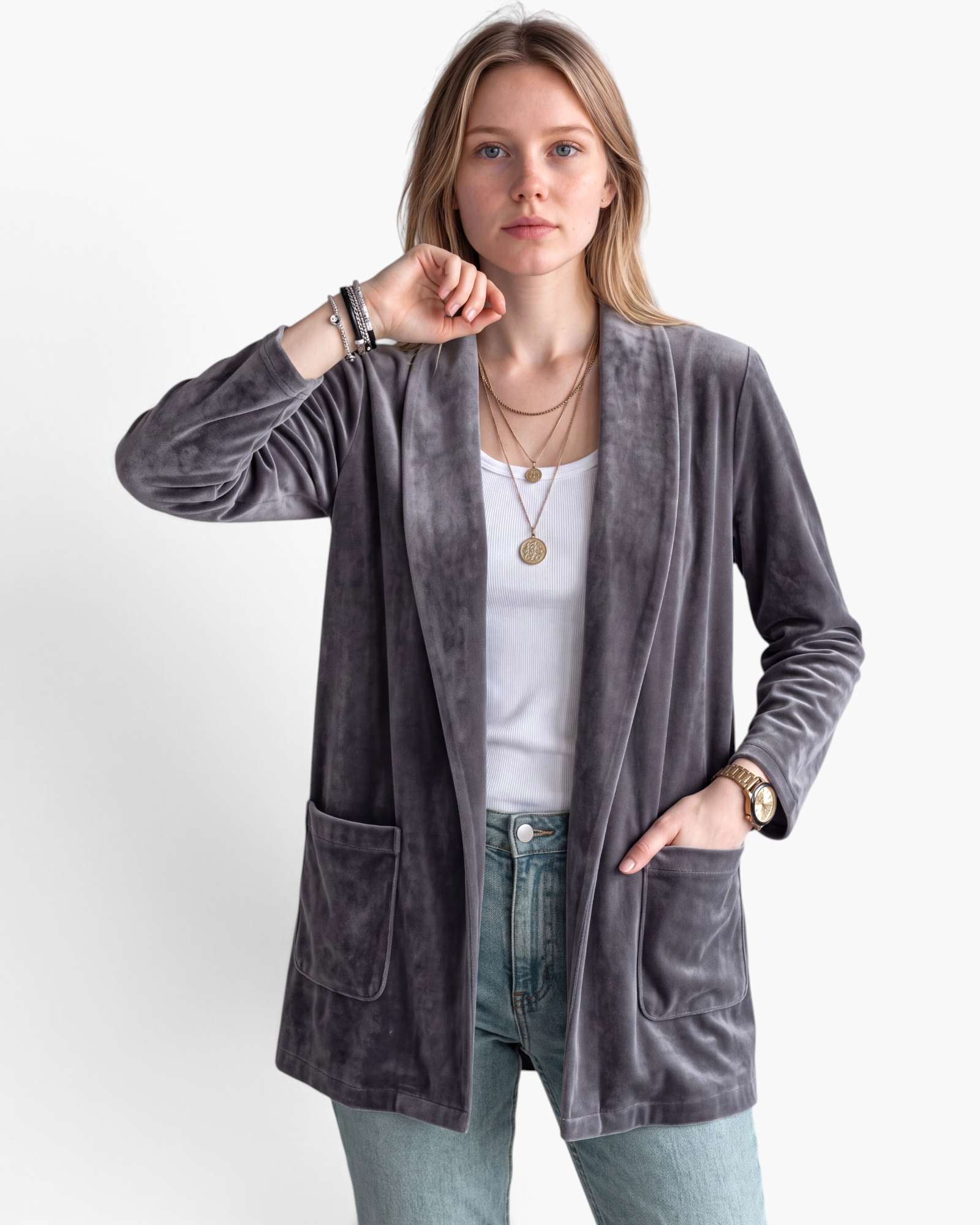 Beach Rose Co. grey velour open-front cardigan with patch pockets worn by a woman over a white tank top and jeans.