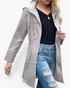Beach Rose Co. grey waterproof hooded rain jacket with zip front, drawstring hood, and gathered waist on a model.
