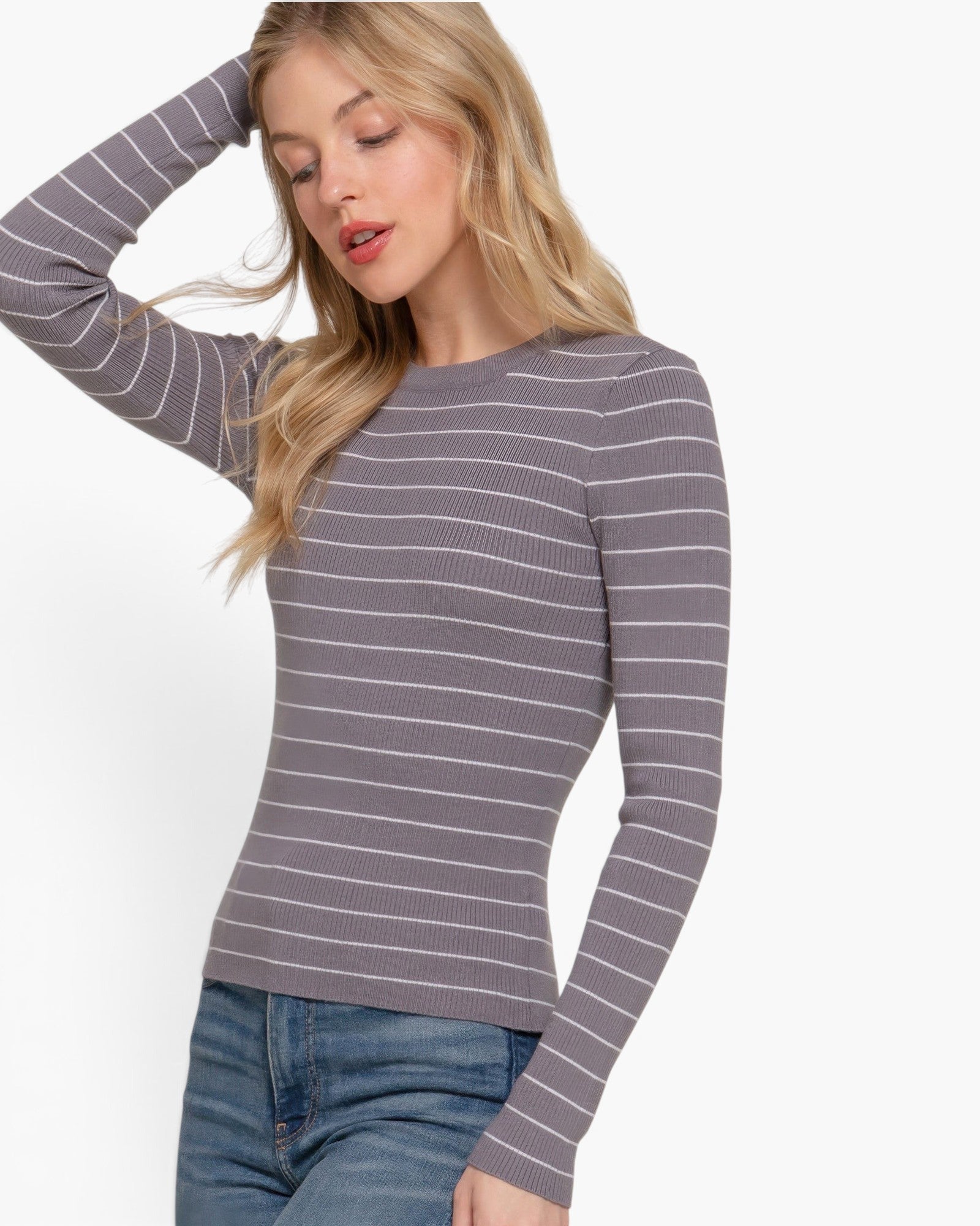 Beach Rose Co. grey and white striped long sleeve crew neck sweater worn by a blonde woman with blue jeans.