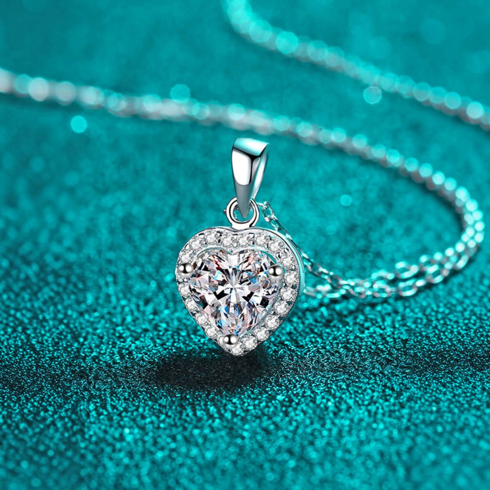Beach Rose Co. silver heart-shaped moissanite pendant necklace with a zircon halo on a delicate link chain.