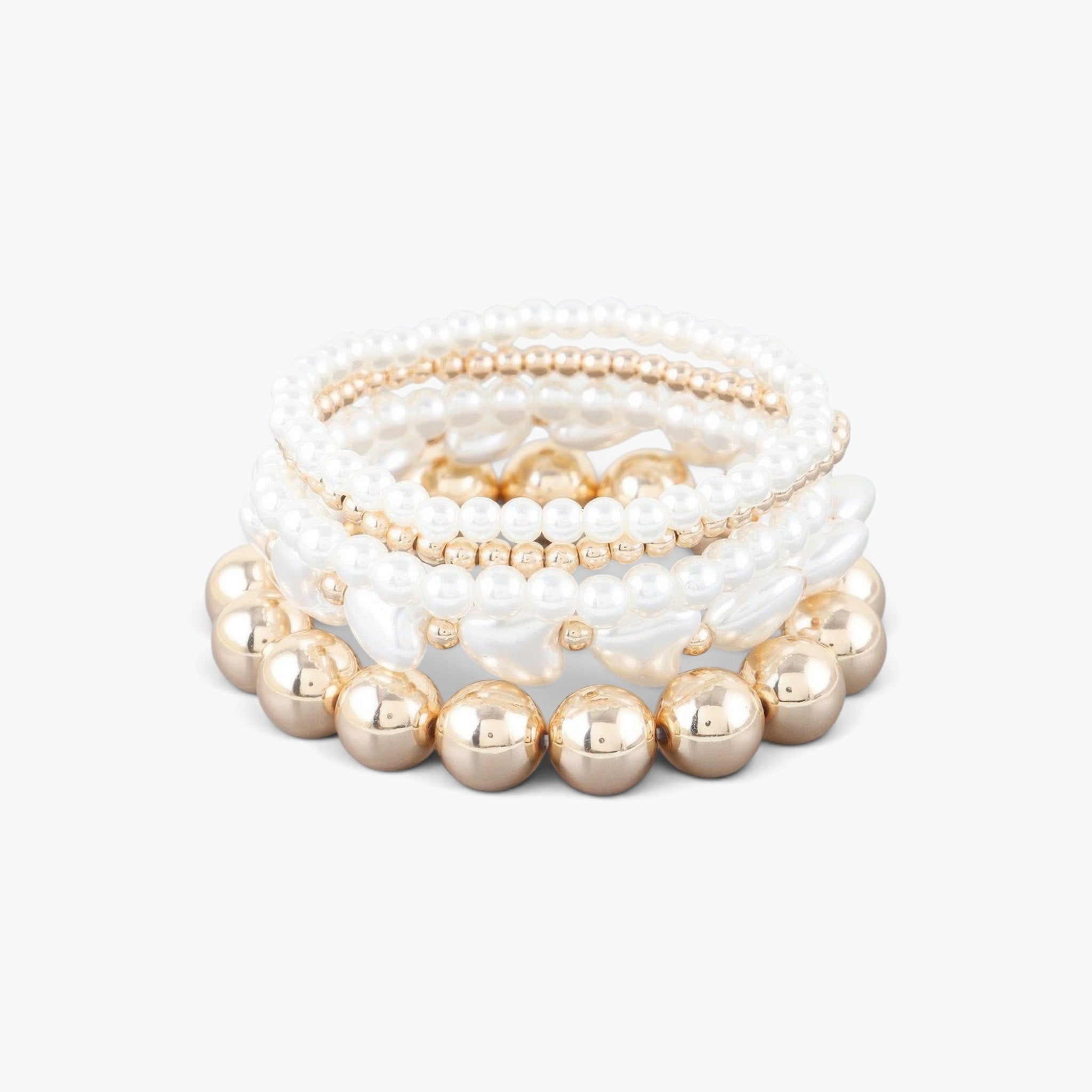 Beach Rose Co. multi-strand bracelet with cream heart stones, gold-plated beads, and white pearls on a white background.
