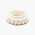 Beach Rose Co. multi-strand bracelet with cream heart stones, gold-plated beads, and white pearls on a white background.