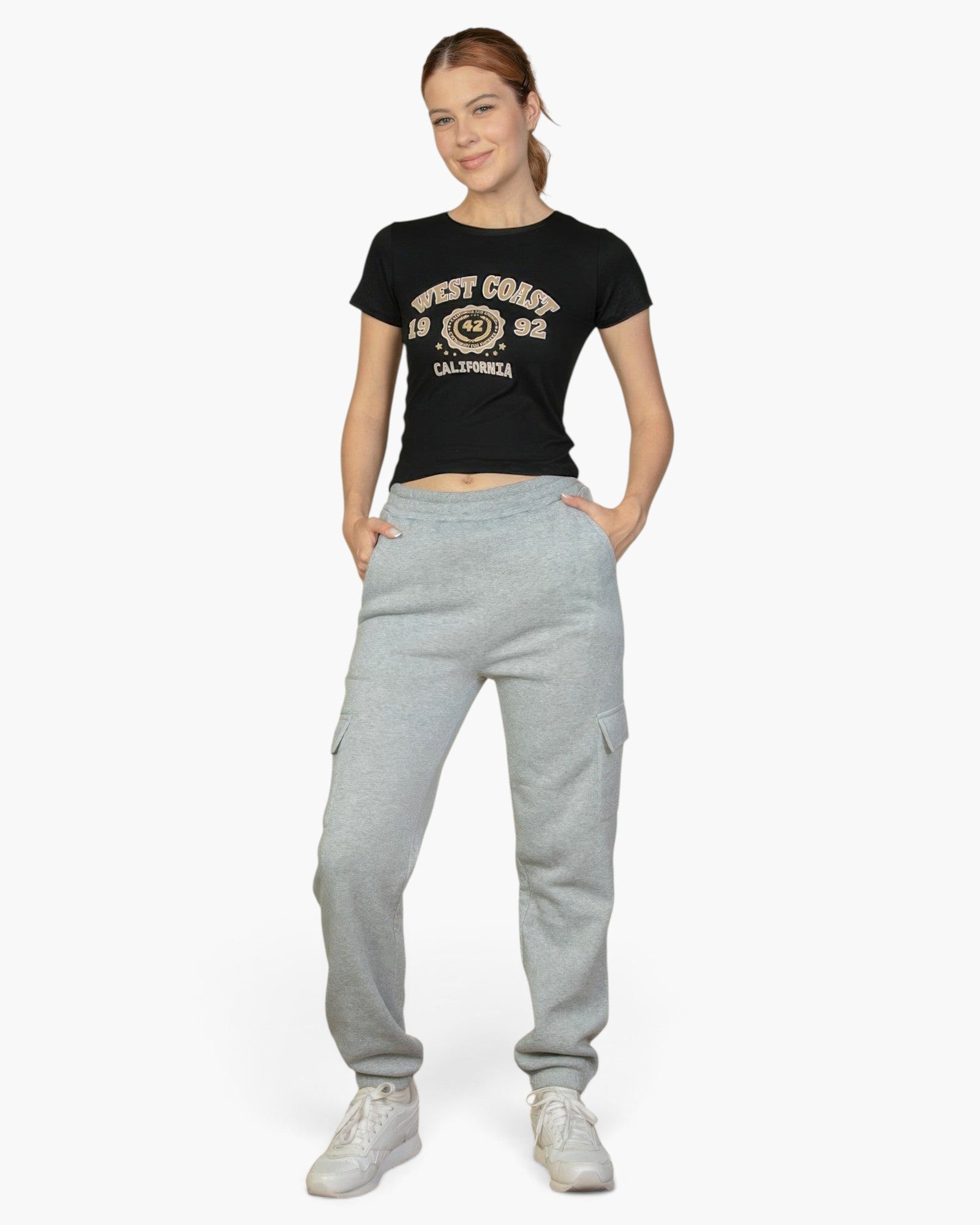 Beach Rose Co. heather gray drawstring sweatpants with side pockets worn by a woman with a black West Coast t-shirt