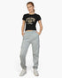 Beach Rose Co. heather gray drawstring sweatpants with side pockets worn by a woman with a black West Coast t-shirt