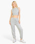 Beach Rose Co. model wearing a heather grey French Terry tank top and matching joggers with an elastic waist.