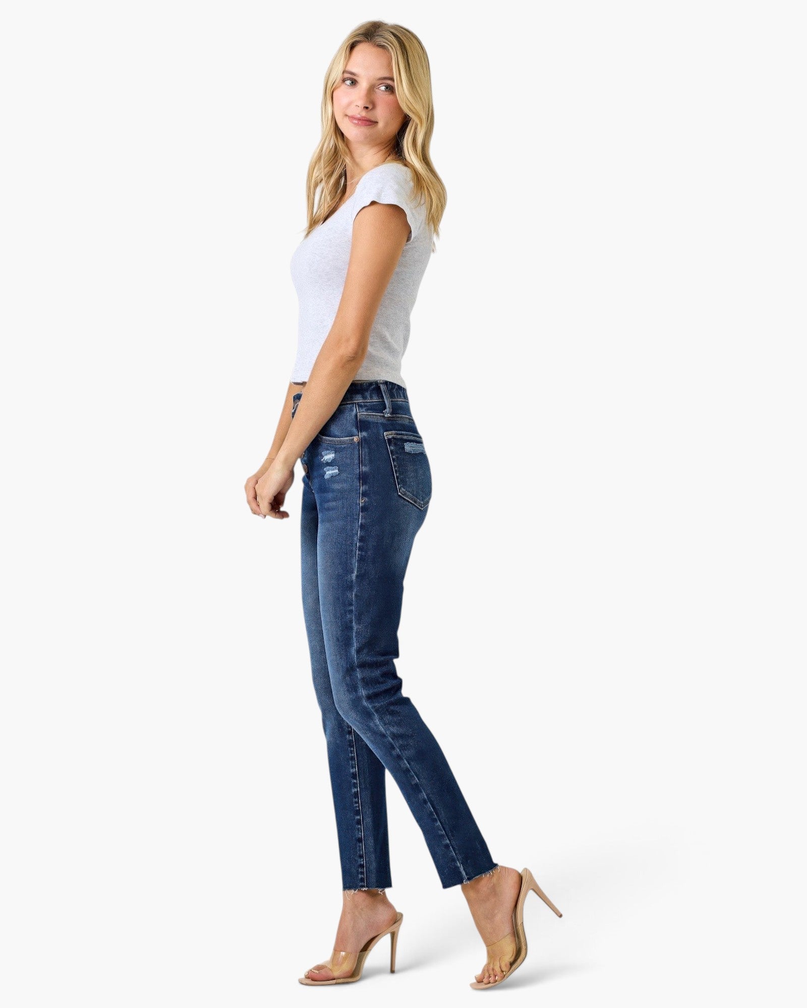 Beach Rose Co. high rise ankle skinny jeans with button fly worn by a blonde model in a white t-shirt and heels