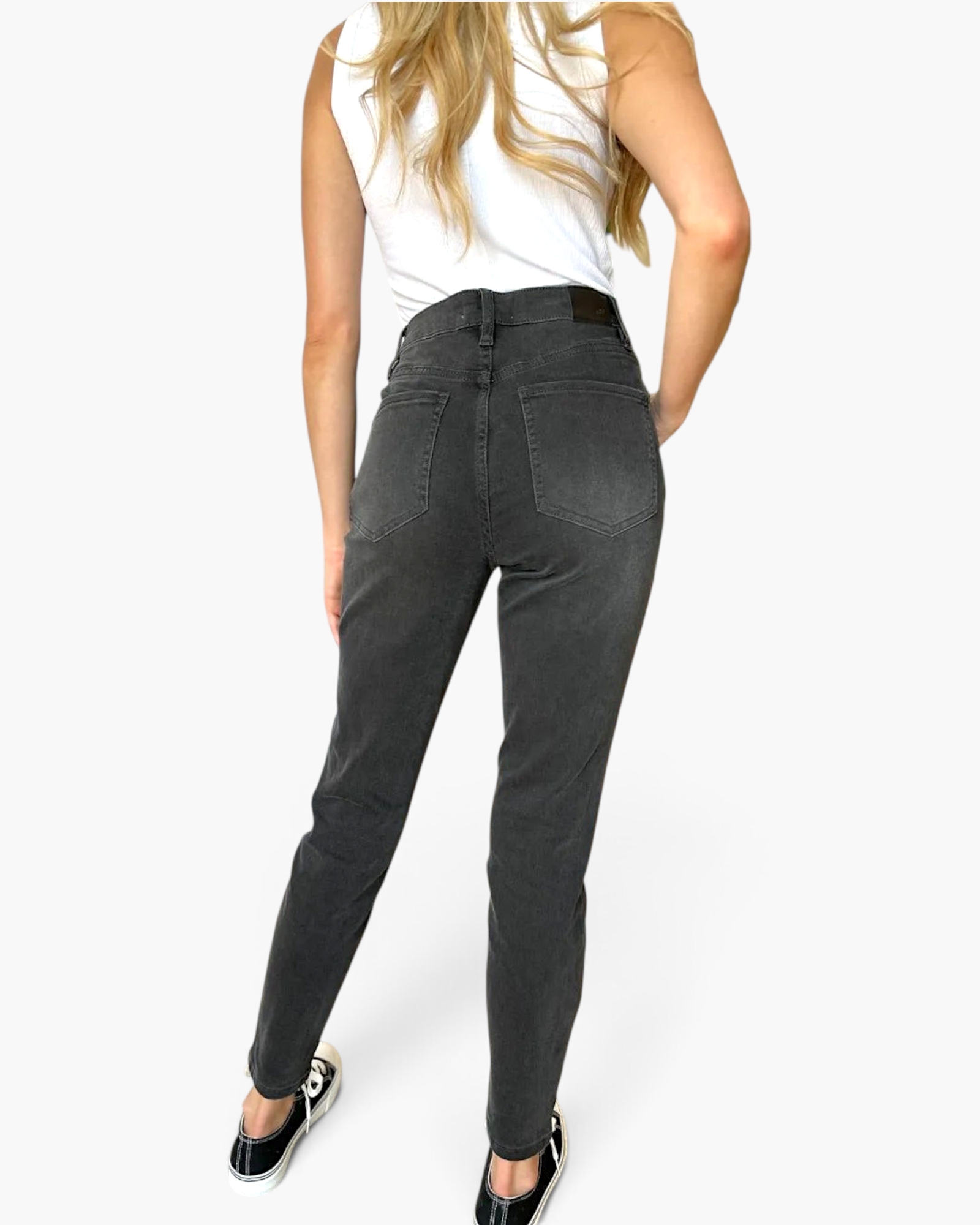 Beach Rose Co. high rise tummy control skinny jeans in washed black denim worn by a model from the back view.