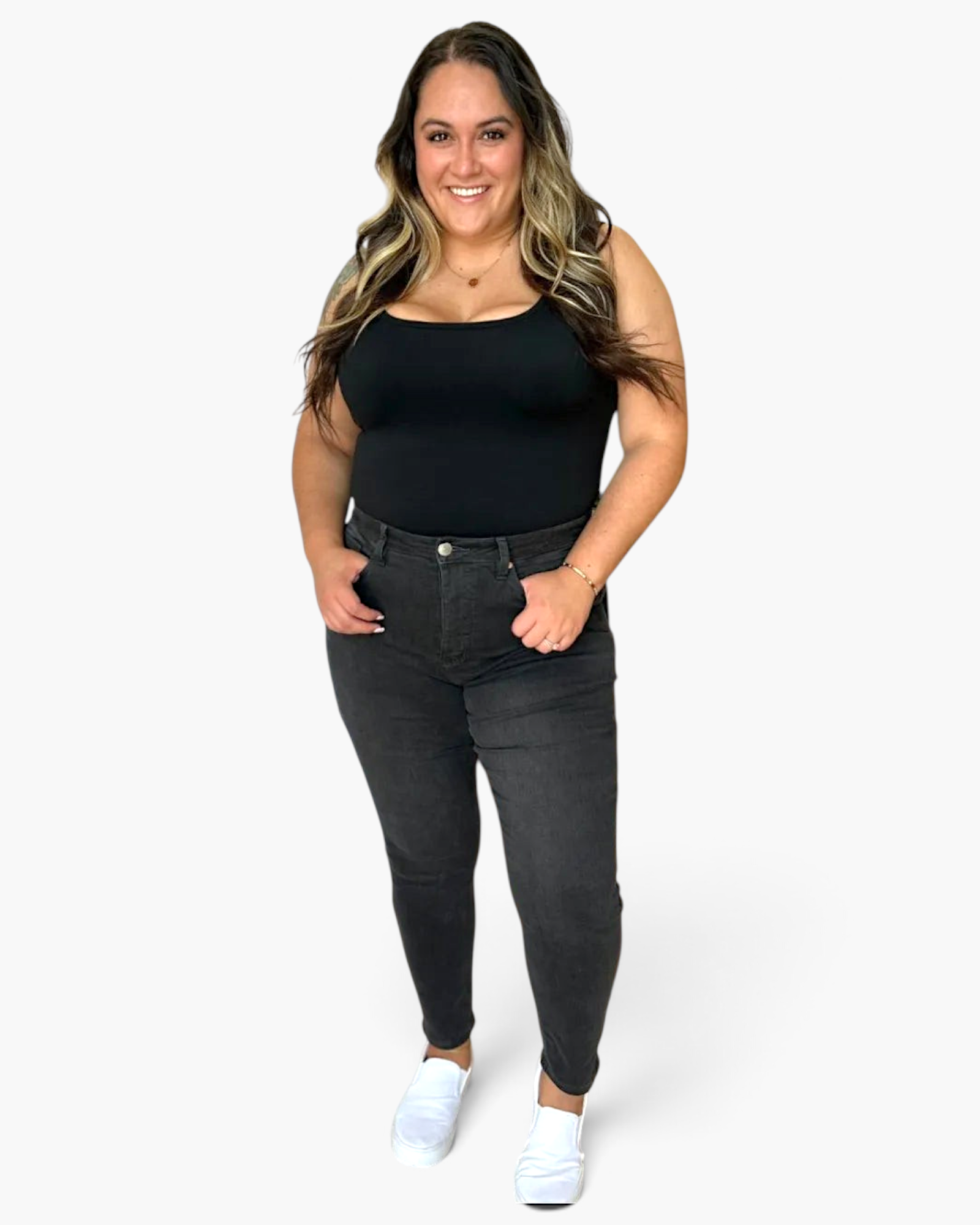 Beach Rose Co. high rise tummy control skinny jeans in dark grey worn by a smiling model with a black tank top