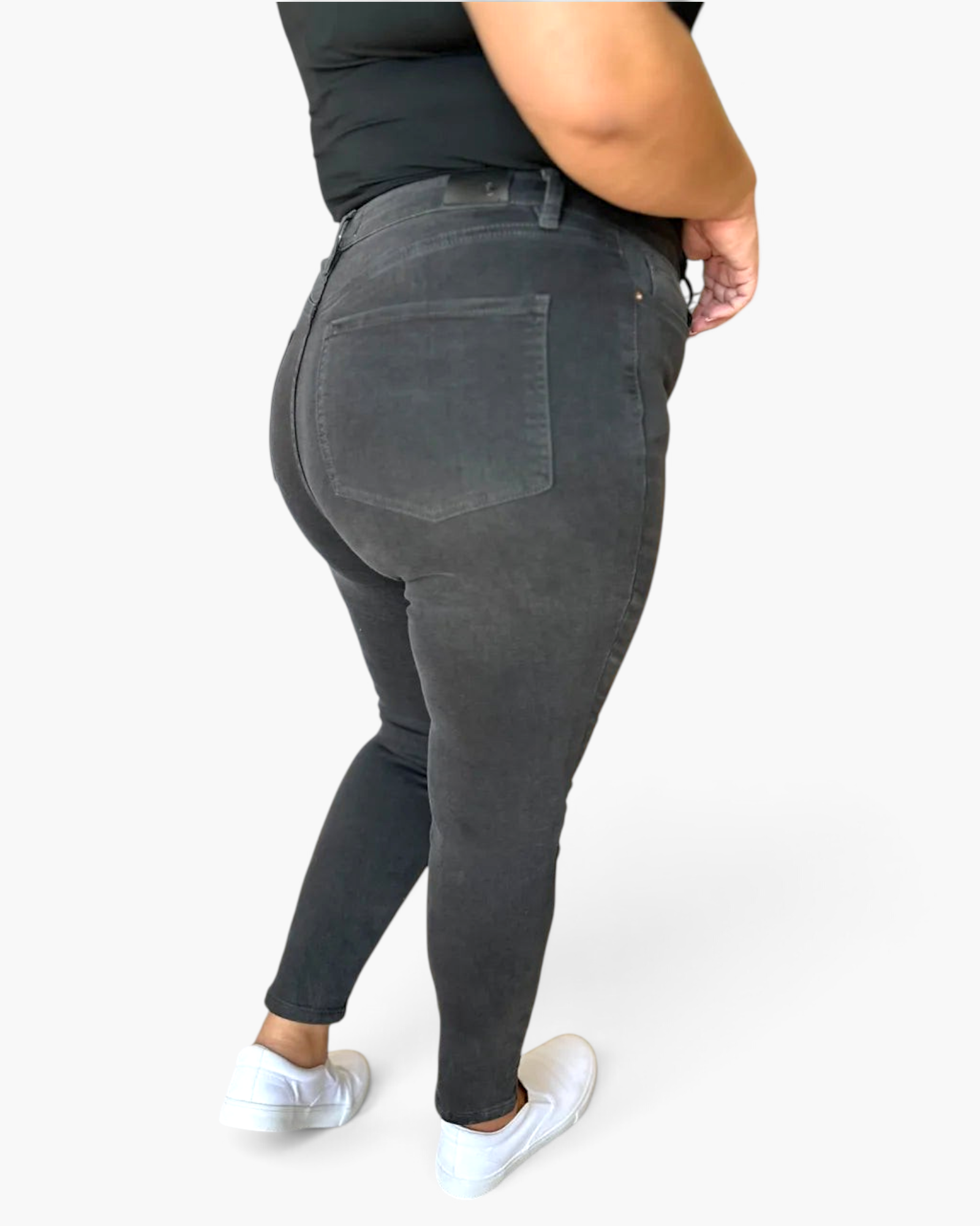 Beach Rose Co. high rise tummy control skinny jeans in charcoal grey with back pockets worn by a plus size model