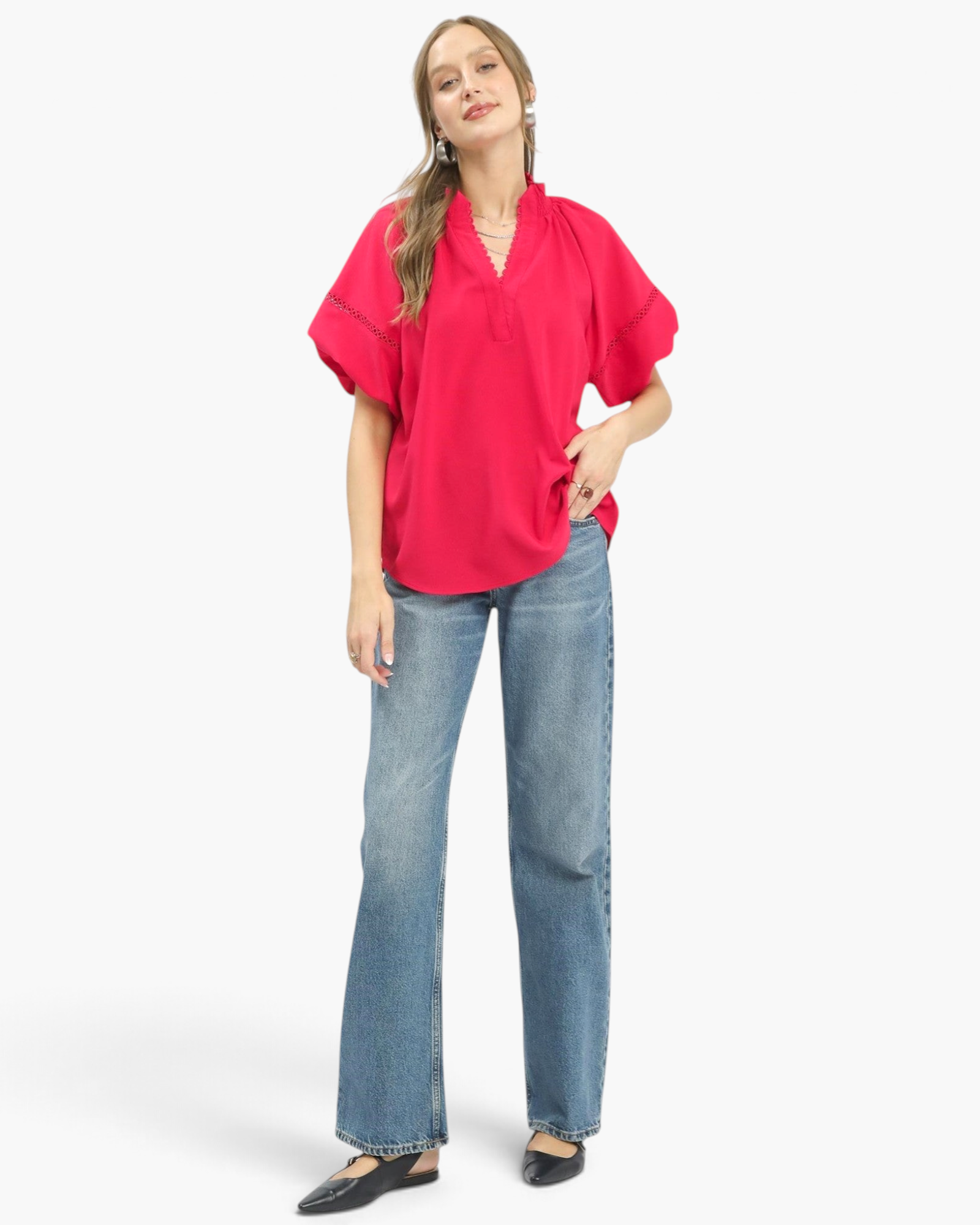 Beach Rose Co. hot pink blouse with smocked stand collar, lace trim, and voluminous sleeves worn with blue jeans.