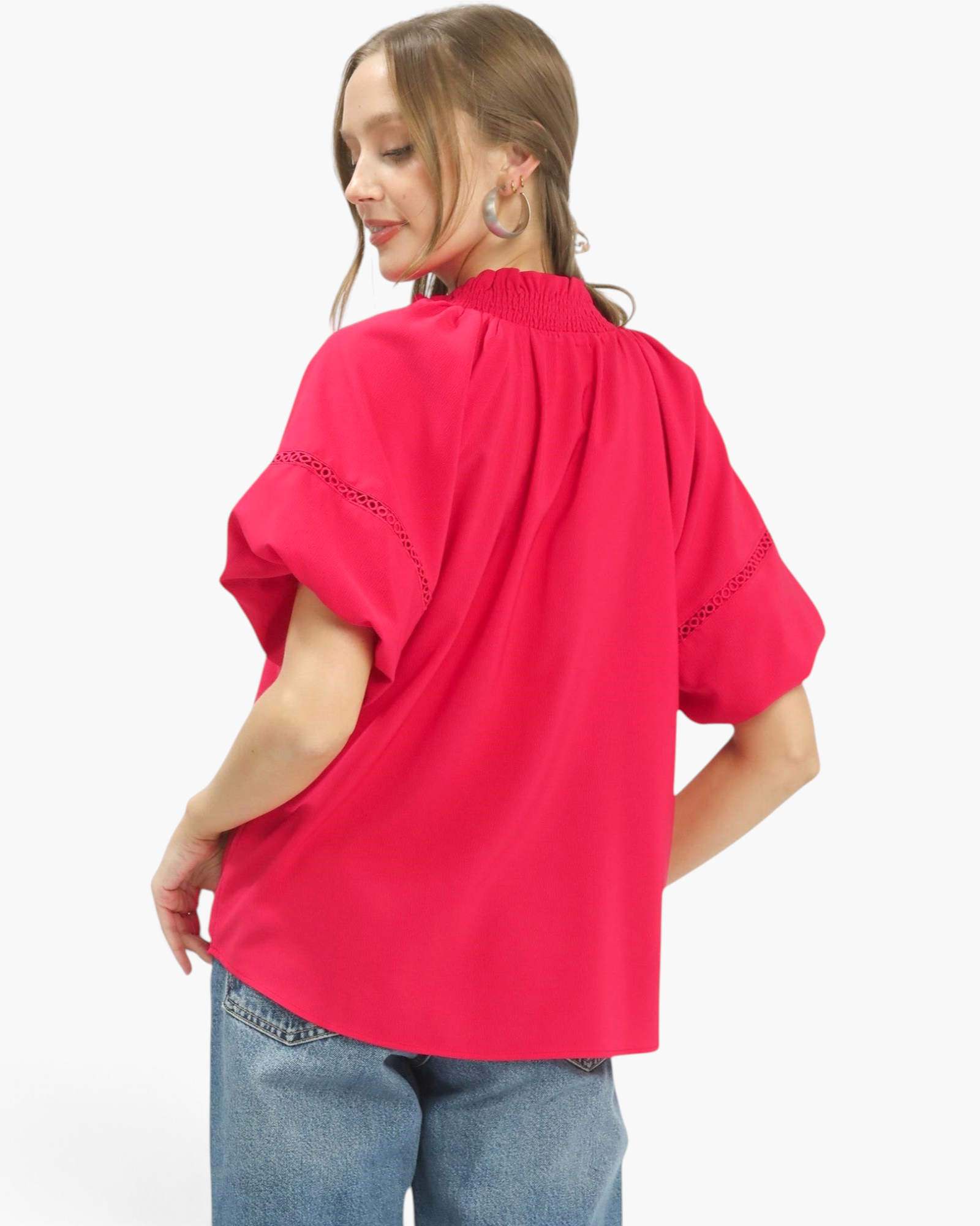 Beach Rose Co. hot pink blouse with smocked stand collar, voluminous short sleeves, and lace inserts, back view.