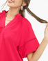 Beach Rose Co. hot pink blouse with a smocked stand collar, scalloped V-neck, and lace insert short sleeves.