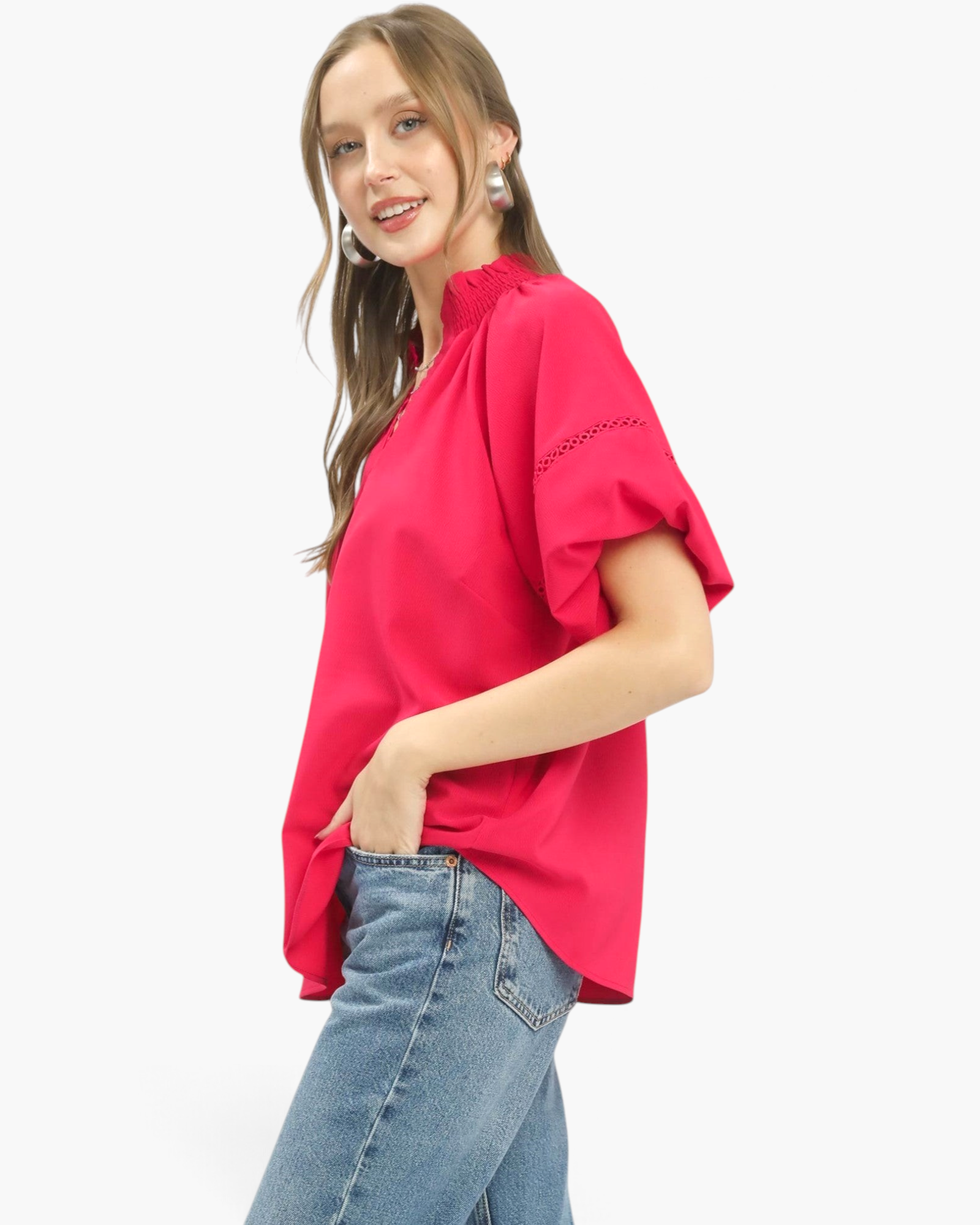Beach Rose Co. hot pink blouse with smocked stand collar, lace sleeve inserts, and relaxed fit worn with blue jeans.