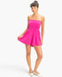 Beach Rose Co. hot pink strapless romper with shirred waist and relaxed shorts worn by a model on a white background