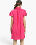 Back view of a Beach Rose Co. hot pink textured shift dress with a ruffled collar and gathered short sleeves.