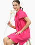 Beach Rose Co. hot pink textured shift dress with a ruffled stand collar, split neckline, and short gathered sleeves.