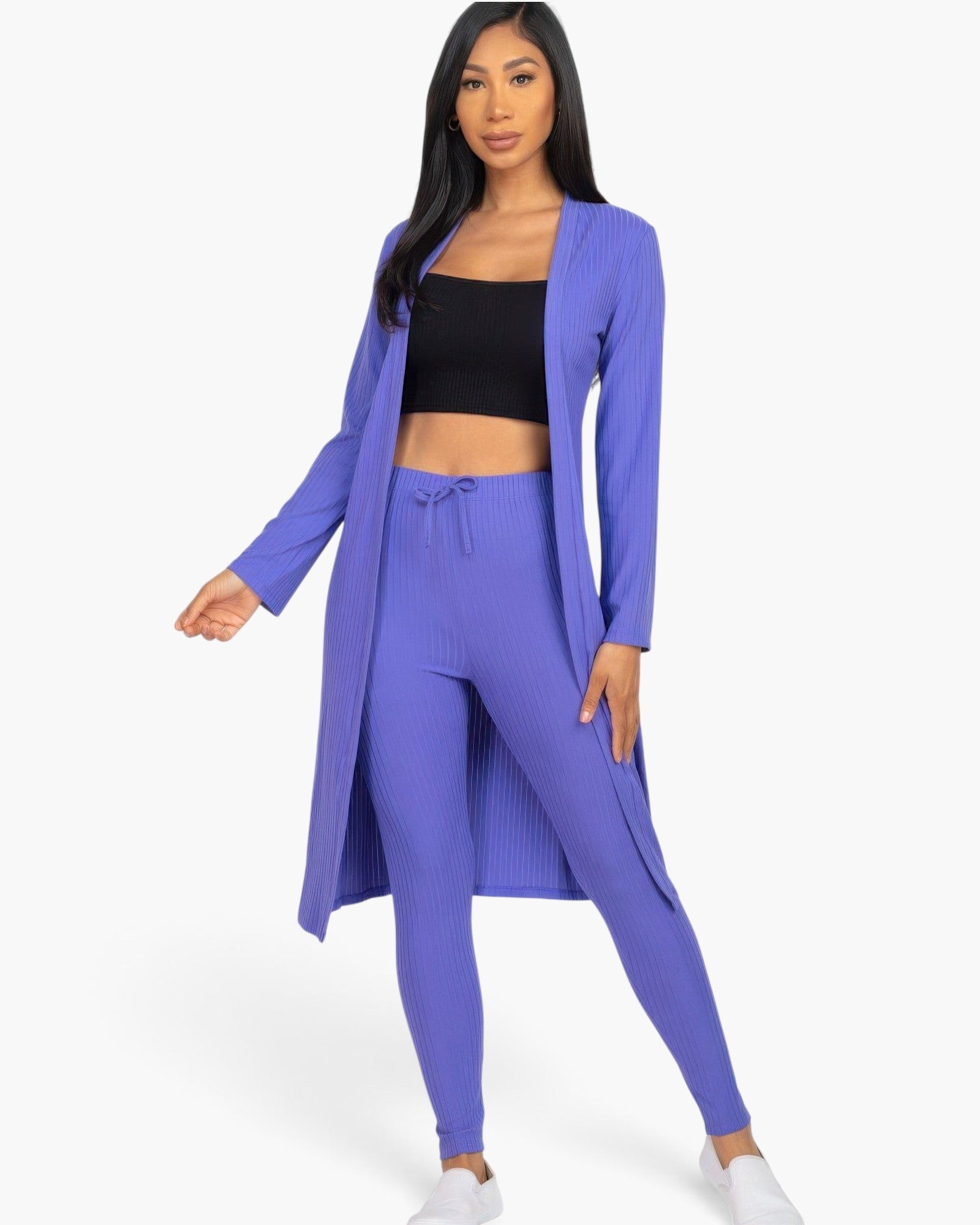Beach Rose Co. model wearing a vibrant Ibiza blue ribbed long cardigan and matching leggings over a black crop top.