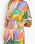 Beach Rose Co. Isla Tropical satin jumpsuit with a boat neck, blouson bodice, and vibrant multi-colored leaf print.