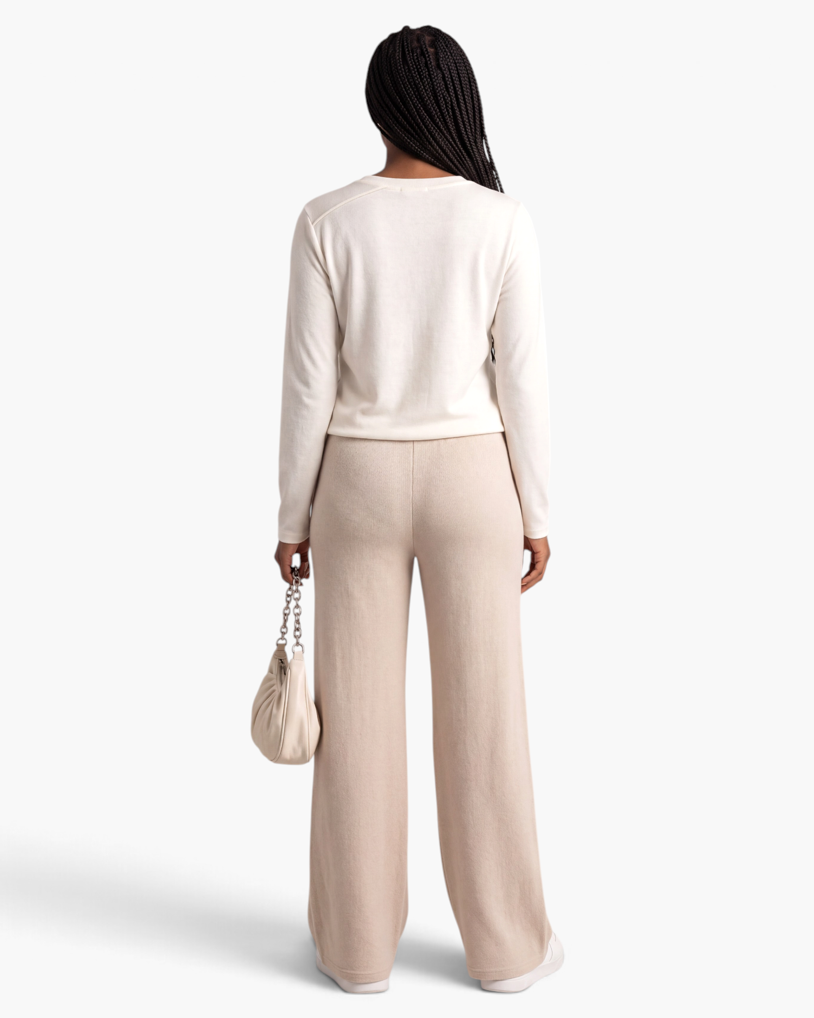 Back view of Beach Rose Co. ivory long-sleeve top and beige wide-leg pants set in fine ribbed fabric.