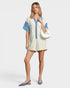 Beach Rose Co. ivory and blue striped collared short-sleeve romper made from a cotton-blend fabric with button front and relaxed fit.
