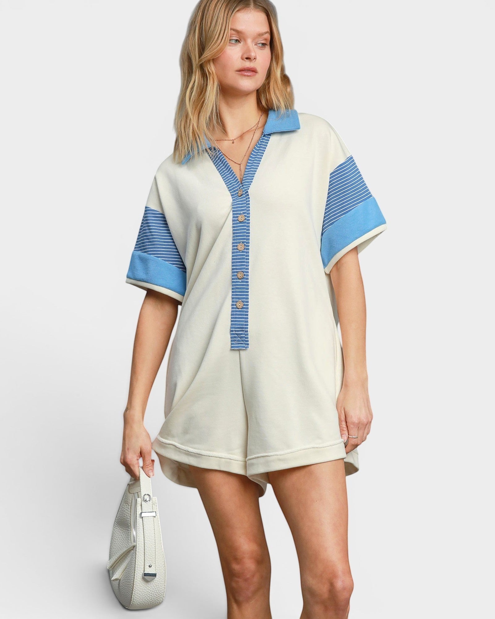 Beach Rose Co. ivory and blue striped cotton-blend romper with collared neckline and button front. Short sleeves, relaxed fit.