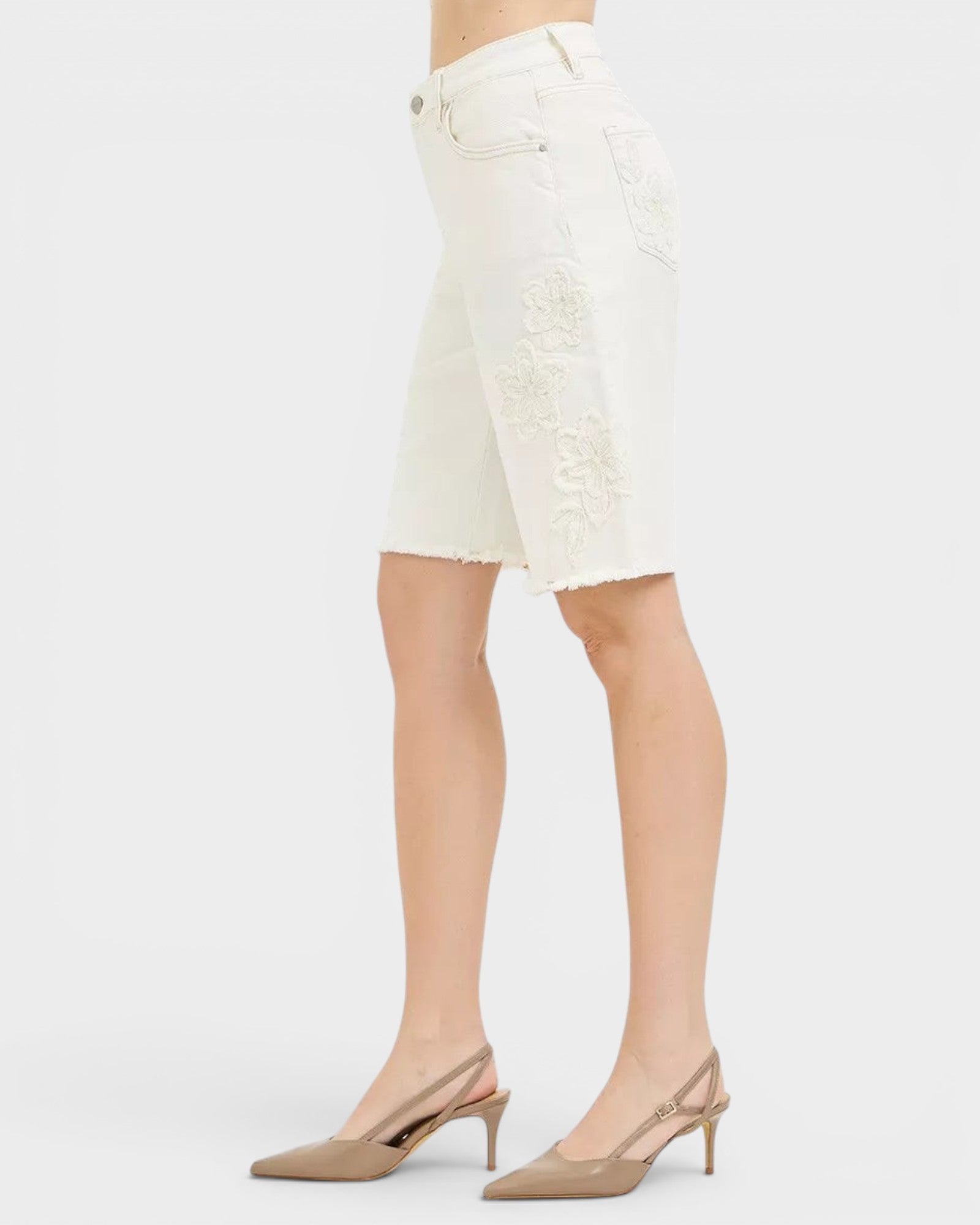 Beach Rose Co. Ivory floral embroidered denim Bermuda shorts with raw hem and stretch fabric.