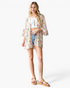 Beach Rose Co. ivory kimono with a multicolor floral print, open front, and flowy three-quarter bell sleeves.