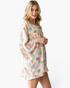 Beach Rose Co. ivory kimono with a multicolor floral print, open front, and flowy bell sleeves on a blonde model.