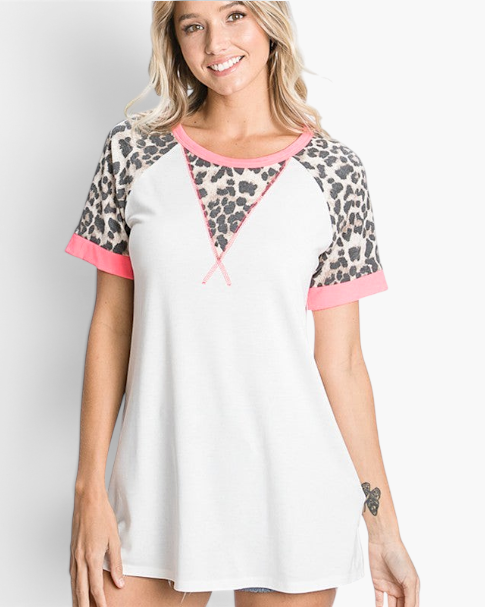Beach Rose Co. ivory raglan top with leopard print sleeves, pink trim, and a relaxed fit worn by a smiling woman.