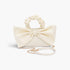 Beach Rose Co. ivory nylon clutch featuring a large front bow, ruched top handle, and detachable gold chain strap.