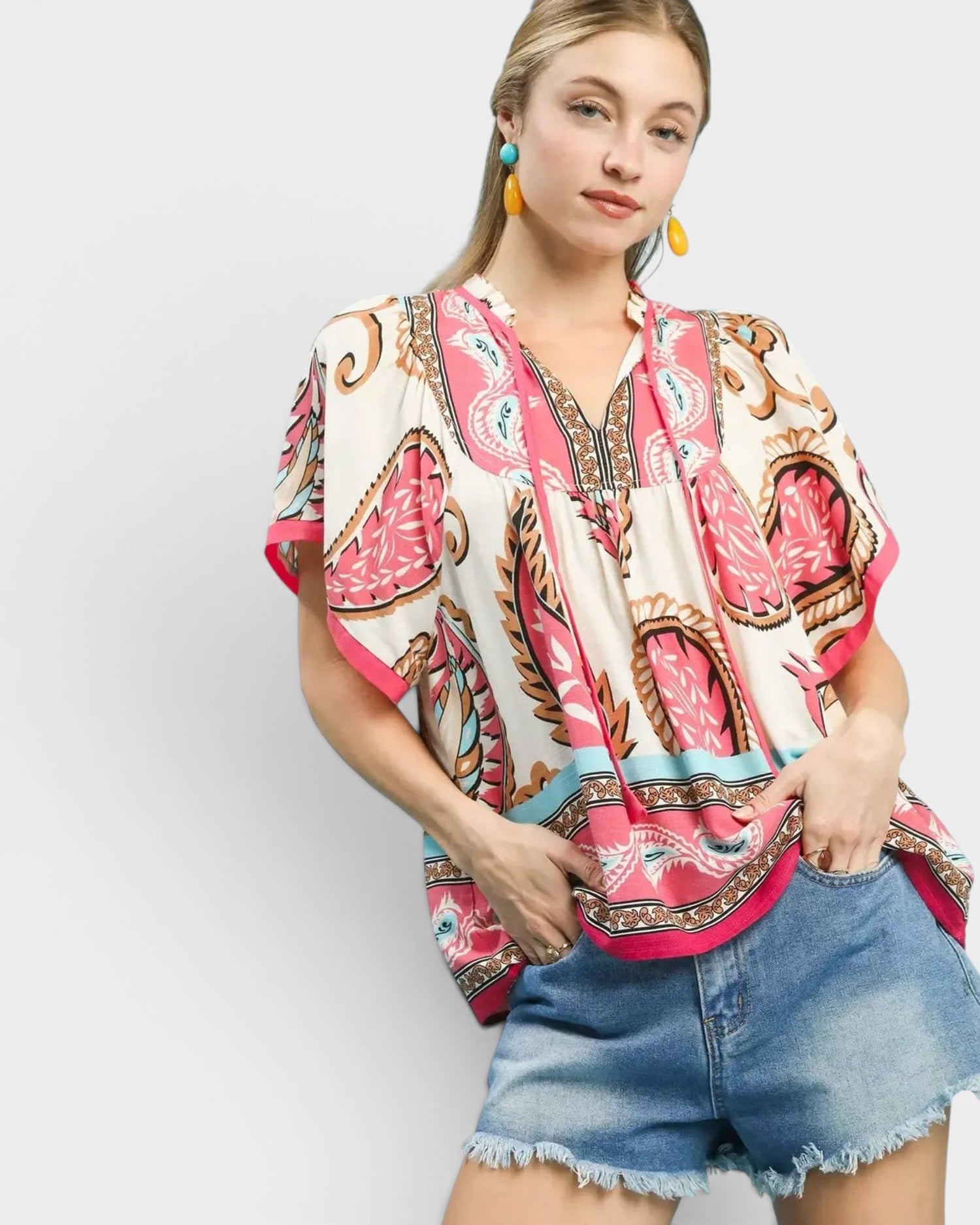 Beach Rose Co. ivory rayon top with pink paisley border print, split neckline, tie detail, and wide short sleeves.