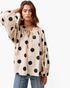 Beach Rose Co. ivory cotton top with black polka dots, long balloon sleeves, and a tie-neck detail on a model