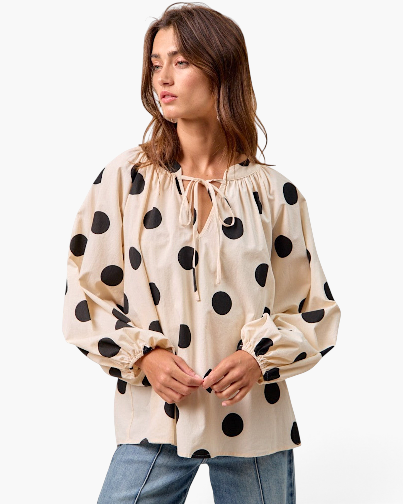 Beach Rose Co. ivory cotton top with black polka dots, featuring a gathered tie-neck and long balloon sleeves.